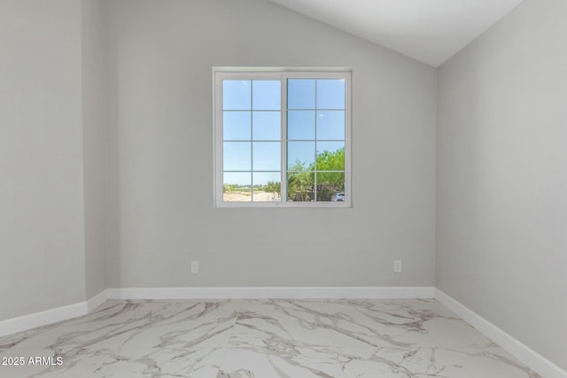 unfurnished room featuring baseboards, marble finish floor, and vaulted ceiling