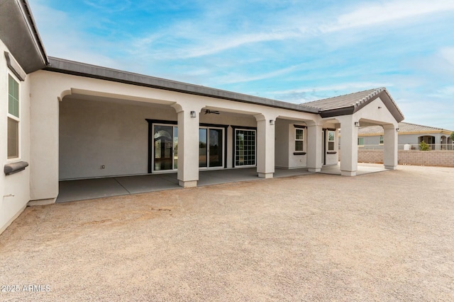 back of house featuring a patio area and stucco siding