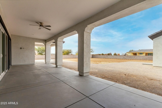 view of patio with fence and a ceiling fan