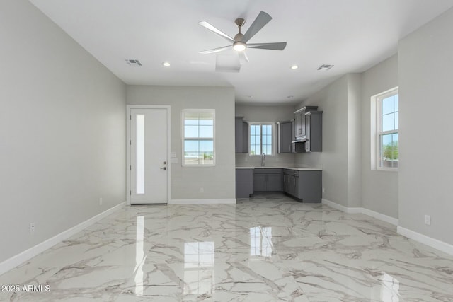 unfurnished living room featuring visible vents, a ceiling fan, marble finish floor, and recessed lighting