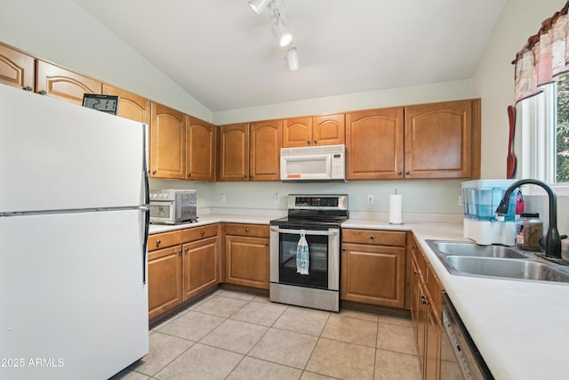 2401 E Antigua Dr, Casa Grande, AZ 85194 - kitchen with white appliances, a sink, lofted ceiling, track lighting, and light countertops