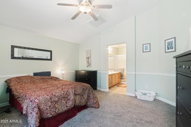 2401 E Antigua Dr, Casa Grande, AZ 85194 - bedroom with vaulted ceiling, light carpet, baseboards, a ceiling fan, and ensuite bath