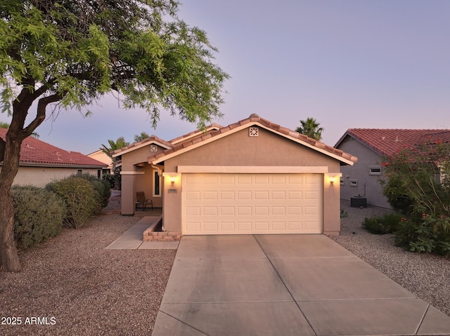 2401 E Antigua Dr, Casa Grande, AZ 85194 - view of front of home featuring stucco siding, driveway, a tiled roof, a garage, and cooling unit