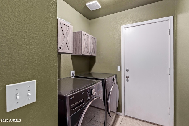5018 W Wikieup Ln, Glendale, AZ 85308 - washroom with cabinet space, washing machine and clothes dryer, light tile patterned floors, and a textured wall