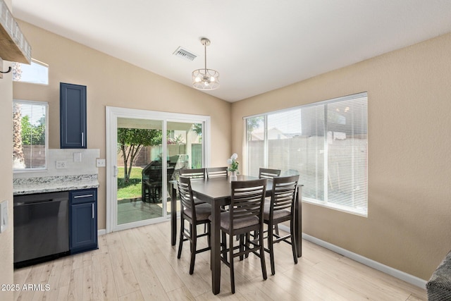 5018 W Wikieup Ln, Glendale, AZ 85308 - dining area featuring a chandelier, light wood-style floors, and lofted ceiling