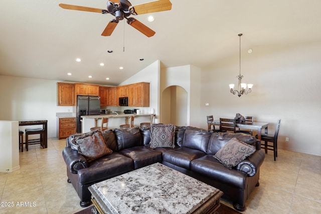 living room featuring arched walkways, light tile patterned floors, recessed lighting, baseboards, and ceiling fan with notable chandelier