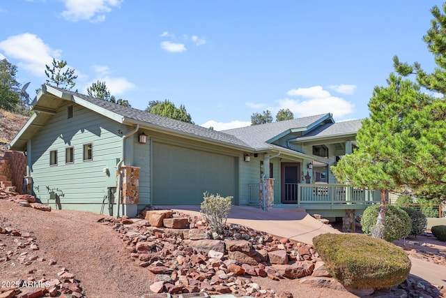 ranch-style house featuring an attached garage and a shingled roof