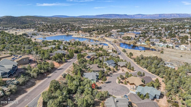 drone / aerial view featuring a residential view and a water and mountain view