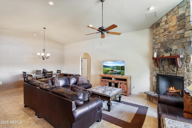 living area featuring visible vents, arched walkways, lofted ceiling, a fireplace, and light tile patterned flooring