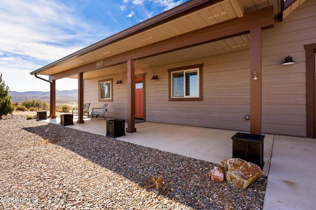 16147 W Apache Way, Peeples Valley, AZ 86332 - back of property featuring a patio area and a mountain view