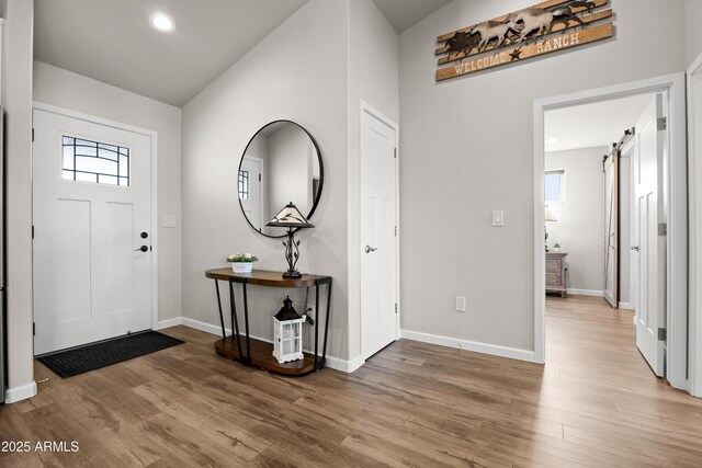 16147 W Apache Way, Peeples Valley, AZ 86332 - entrance foyer featuring recessed lighting, a barn door, light wood-style floors, and baseboards