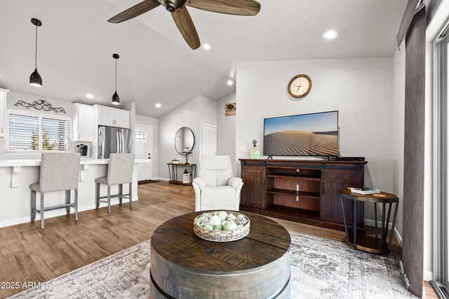 16147 W Apache Way, Peeples Valley, AZ 86332 - living area featuring baseboards, light wood-type flooring, vaulted ceiling, and ceiling fan