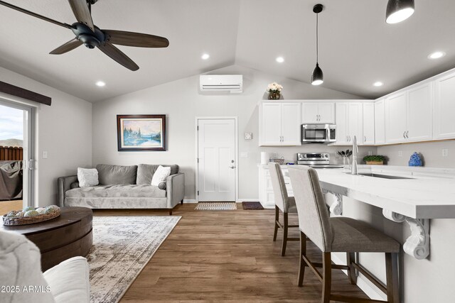 16147 W Apache Way, Peeples Valley, AZ 86332 - living room featuring a wall mounted AC, wood finished floors, vaulted ceiling, and recessed lighting
