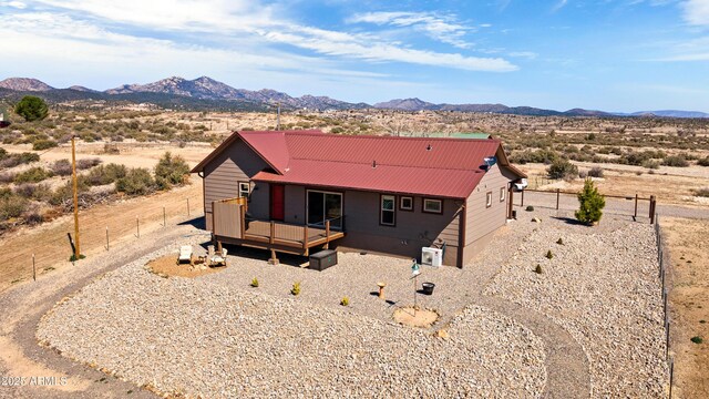 16147 W Apache Way, Peeples Valley, AZ 86332 - exterior space with a deck with mountain view, metal roof, a desert view, and fence