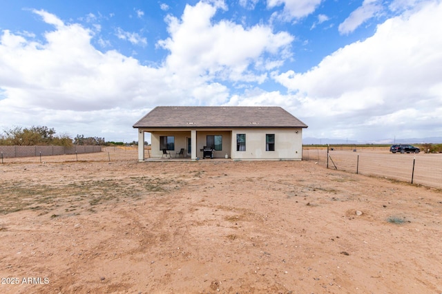 rear view of property with fence