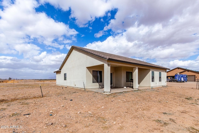 rear view of property featuring a patio area and stucco siding