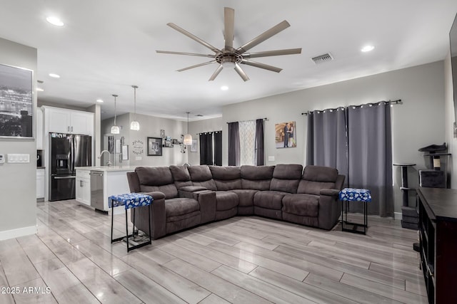 living room featuring a ceiling fan, recessed lighting, visible vents, and wood tiled floor