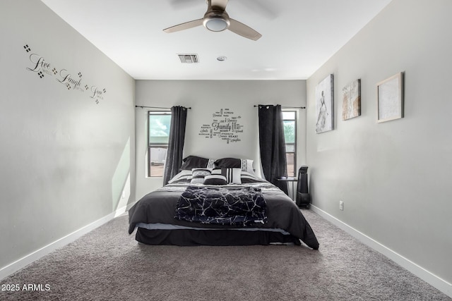 carpeted bedroom with baseboards, visible vents, and a ceiling fan