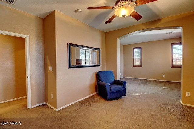 unfurnished room with ceiling fan and light colored carpet