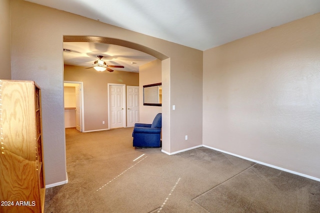 spare room featuring ceiling fan and carpet floors