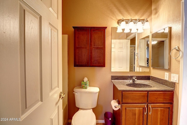 bathroom featuring toilet and vanity