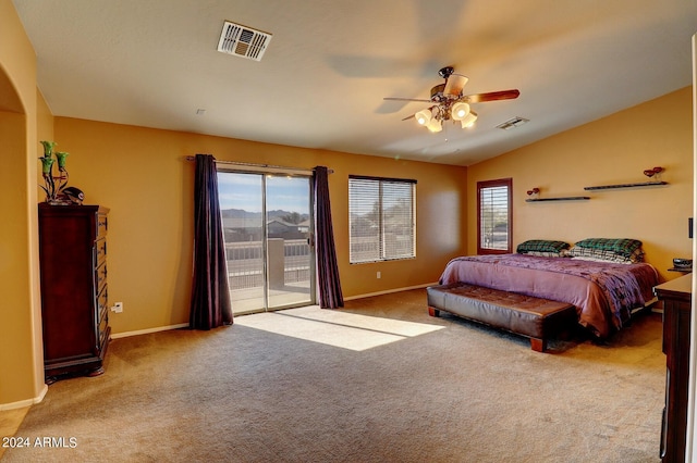 carpeted bedroom featuring multiple windows, vaulted ceiling, ceiling fan, and access to outside