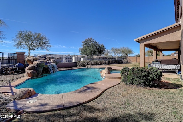 view of swimming pool with pool water feature