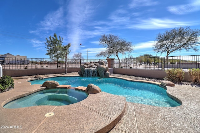 view of pool with an in ground hot tub