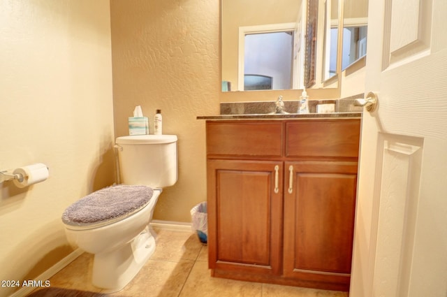 bathroom featuring vanity, toilet, and tile patterned floors