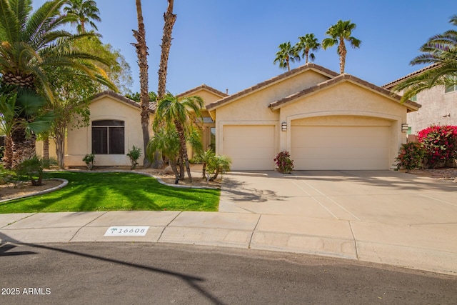 view of front of property with stucco siding, concrete driveway, a garage, a tiled roof, and a front lawn