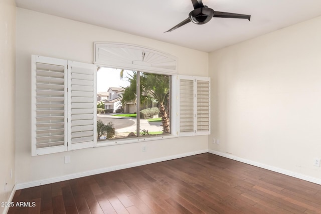 spare room with a ceiling fan, baseboards, and wood finished floors