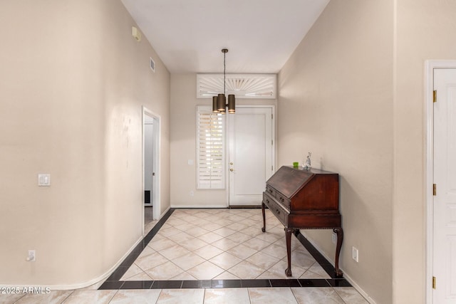 foyer with tile patterned flooring and baseboards