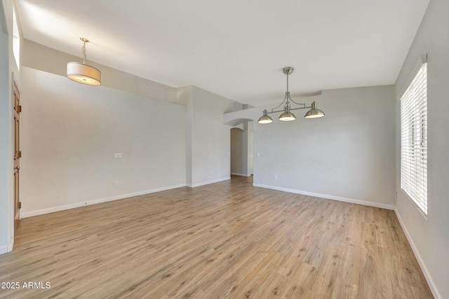 166 W Merrill Ct, Gilbert, AZ 85233 - spare room with a chandelier, light wood-type flooring, and plenty of natural light
