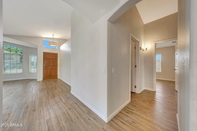 166 W Merrill Ct, Gilbert, AZ 85233 - foyer with vaulted ceiling, light wood-style floors, and arched walkways