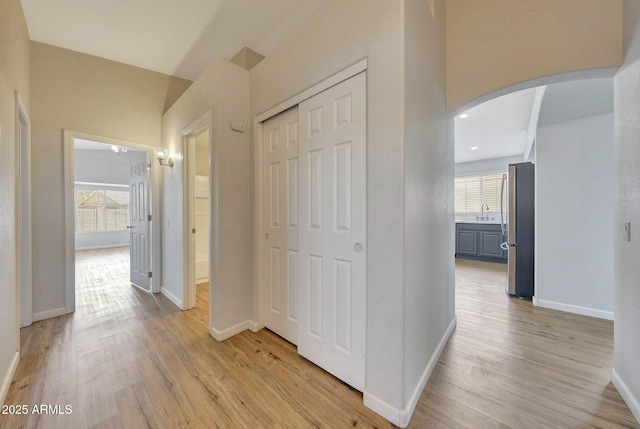 166 W Merrill Ct, Gilbert, AZ 85233 - hallway with arched walkways, light wood-style flooring, and recessed lighting
