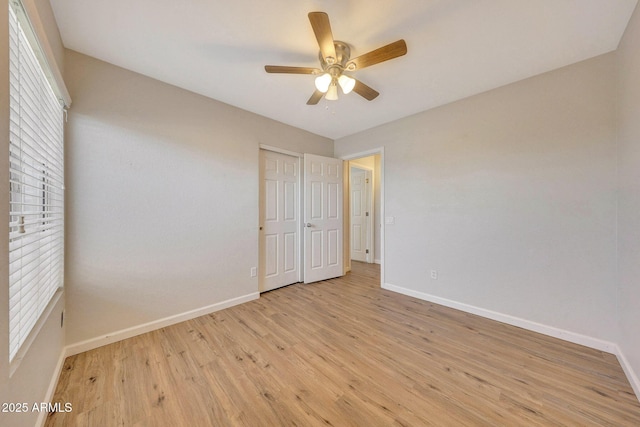 166 W Merrill Ct, Gilbert, AZ 85233 - unfurnished bedroom featuring light wood-style floors, a ceiling fan, and a closet