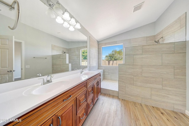 166 W Merrill Ct, Gilbert, AZ 85233 - bathroom with vaulted ceiling, walk in shower, double vanity, and wood finished floors
