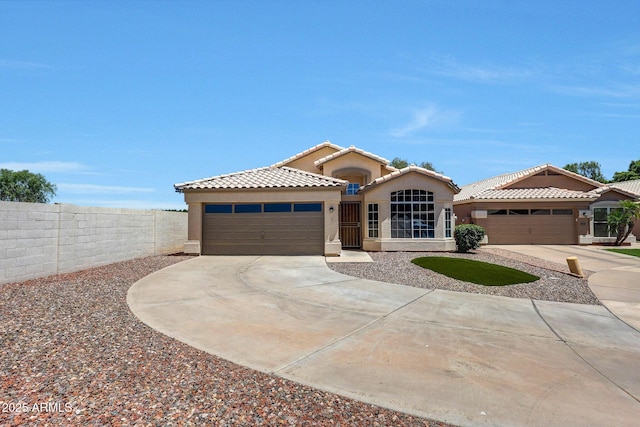 166 W Merrill Ct, Gilbert, AZ 85233 - mediterranean / spanish-style home with driveway, an attached garage, stucco siding, and a tiled roof