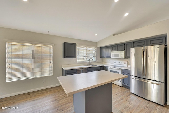166 W Merrill Ct, Gilbert, AZ 85233 - kitchen with stainless steel appliances, gray cabinets, light countertops, light wood-style flooring, and lofted ceiling