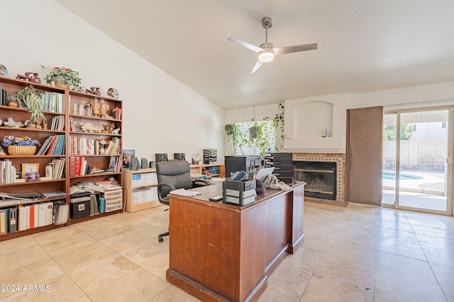 office area featuring ceiling fan, light tile patterned floors, and vaulted ceiling