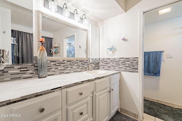 bathroom featuring decorative backsplash, vanity, and tile patterned floors