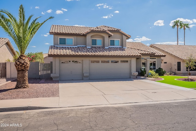 mediterranean / spanish-style house featuring a garage, a tile roof, fence, driveway, and stucco siding