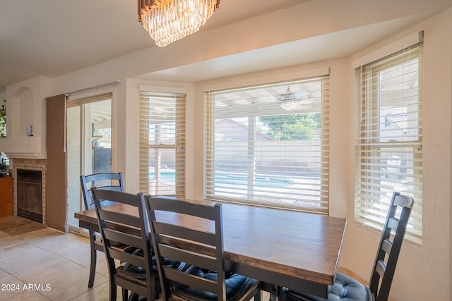 tiled dining space featuring a chandelier