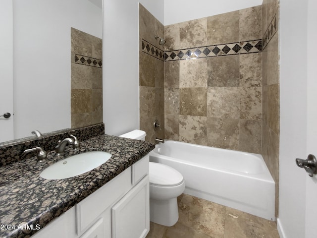 full bathroom with vanity, tiled shower / bath combo, and toilet