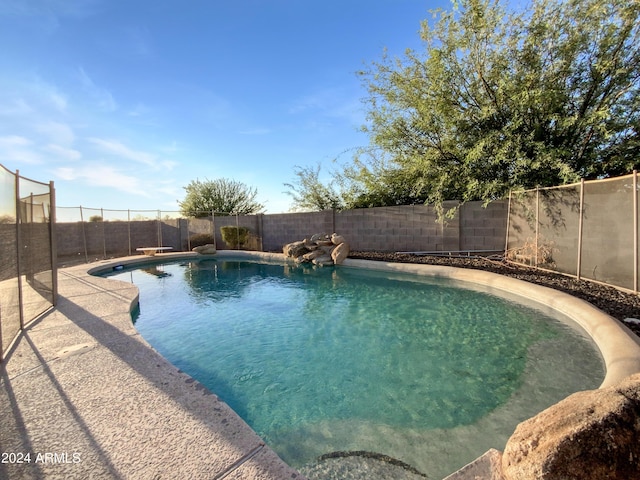 view of pool with a diving board