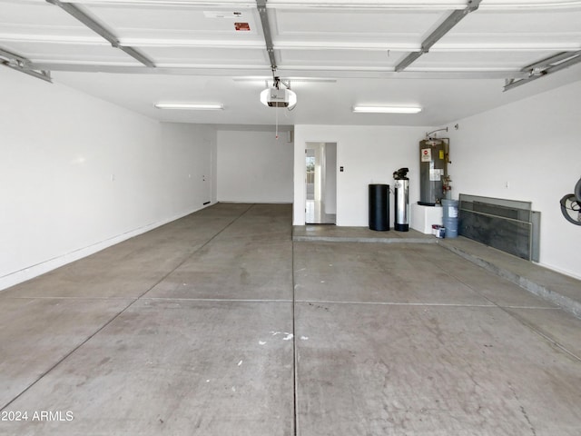 garage featuring a garage door opener and water heater