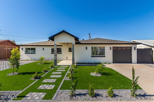 ranch-style house with a garage and a front lawn