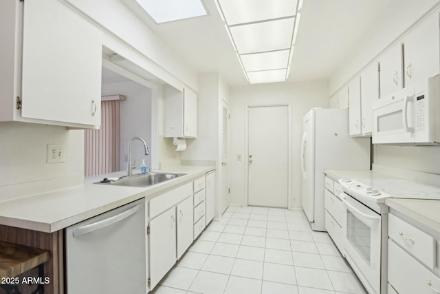 kitchen with white cabinetry, sink, light tile patterned floors, and white appliances