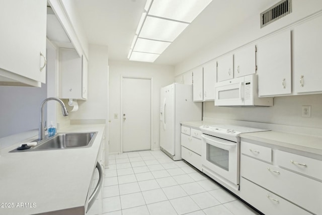 kitchen featuring white cabinets, light tile patterned floors, white appliances, and sink