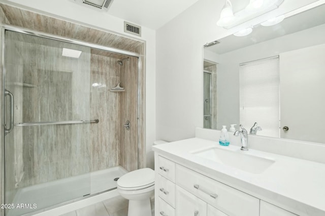 bathroom with an enclosed shower, vanity, toilet, and tile patterned flooring